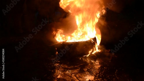 burning wheel closeup in the night, danger fire flame, stress euromaidan diversity photo