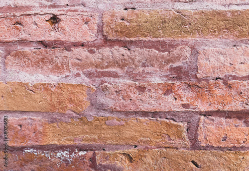 A red brick wall, The bricks are uniform in size and shape, arranged in a traditional brick bond pattern rows offset from each other. The white color of the bricks gives the wall a modern look