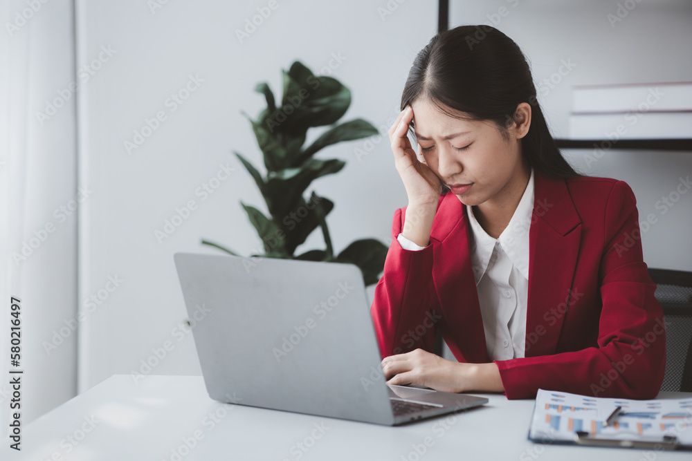 Businesswoman suffering from stress and office syndrome, Asian business owner runs finance management, she set up startup company, modern female leadership. Business woman leader concept. Businesswoman suffering from stress and office syndrome, Asian business owner runs finance management, she set up startup company, modern female leadership. Business woman leader concept.