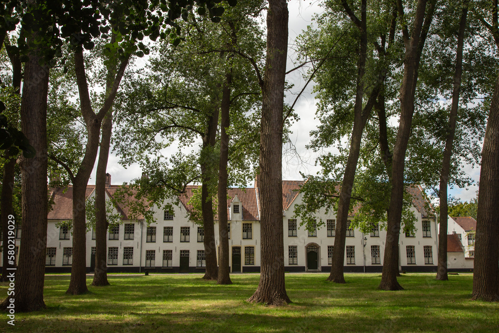 Flemish and ornate architecture of idyllic Bruges with garden park, Flanders, Belgium