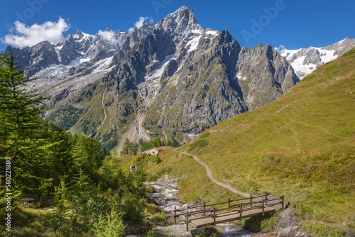 Landscape of Aosta valley near Mont Blanc massif with river and bridge, Italy