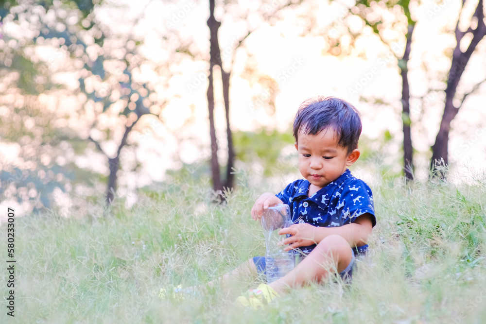 Happy asian boy playing on green grass outdoor park Happy asian boy playing on green grass outdoor park