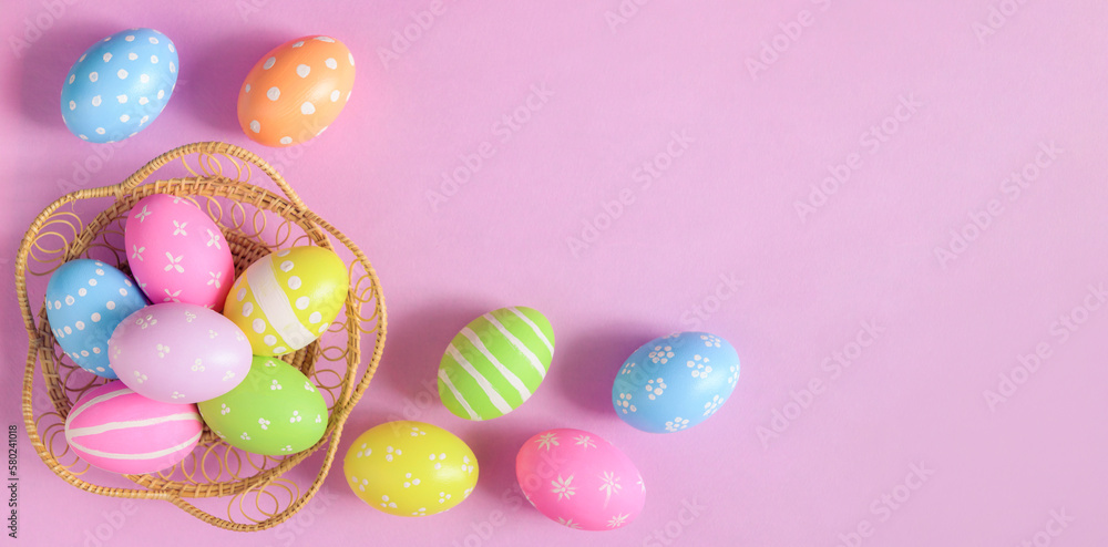 Happy Easter holiday greeting card concept. Colorful Easter Eggs and spring flowers on pastel pink background. Flat lay, top view, copy space. Happy Easter holiday greeting card concept. Colorful Easter Eggs and spring flowers on pastel pink background. Flat lay, top view, copy space.