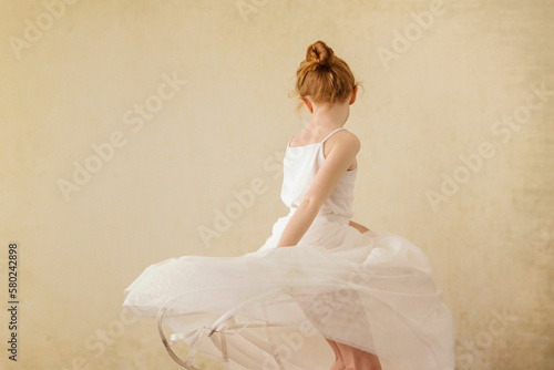 Girl dancing against wall