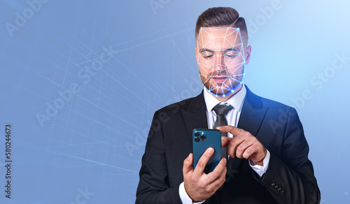 Businessman working with smartphone, facial recognition and auth photo
