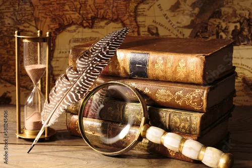 Obraz Antique still life. Medieval table with old map, magnifying glass, books, quill pen, sandwatch.