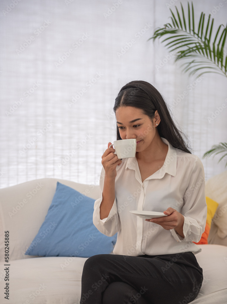 Banner of Asian woman Proprietor holding hot coffee in white ceramic cup to sniff smell of espresso in office work place . business owner entrepreneur girl carry coffee break to sniff fragrant smell Banner of Asian woman Proprietor holding hot coffee in white ceramic cup to sniff smell of espresso in office work place . business owner entrepreneur girl carry coffee break to sniff fragrant smell
