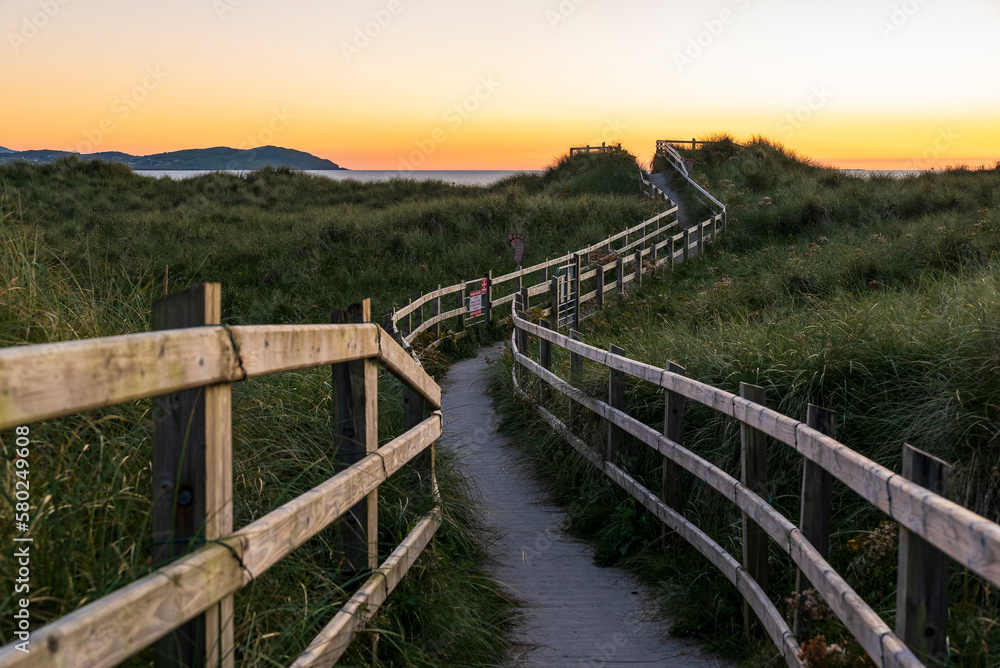 Wooden walkway with railing leading towards Dooey beach, County Donegal, Ireland
