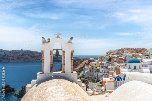 Fotomurale White bell tower in the background of the city of Oia