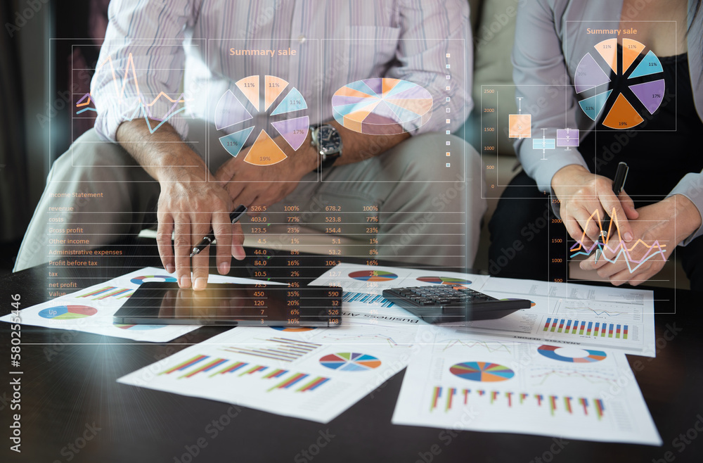 business team using touchpad computer with financial report spreadsheet ...