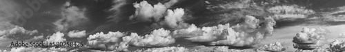 Panorama Of Cloudy Sky. Natural Day Cloudy Sky Abstract Background. Panorama Panoramic View. Backdrop. Copy Space. Black And White Colors.