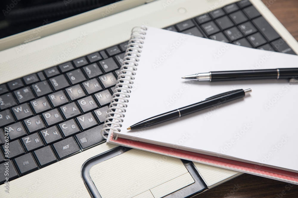 Black pen on the computer keyboard. Black pen on the computer keyboard.