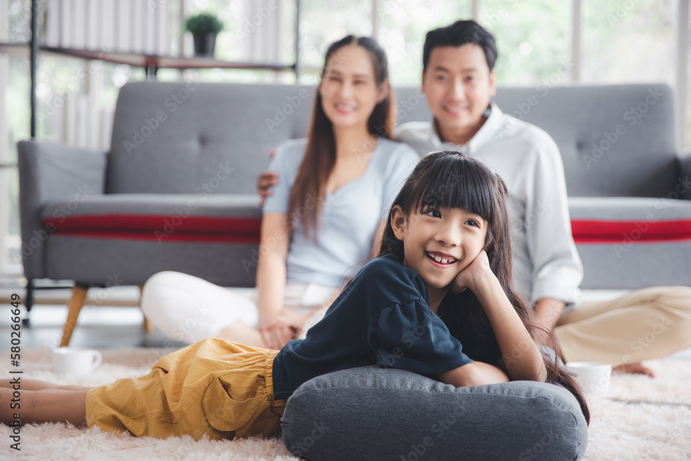 Asian kid cute girl lying on mom and dad happy living relaxing with young mom and dad at home, Happy young family living concept Asian kid cute girl lying on mom and dad happy living relaxing with young mom and dad at home, Happy young family living concept