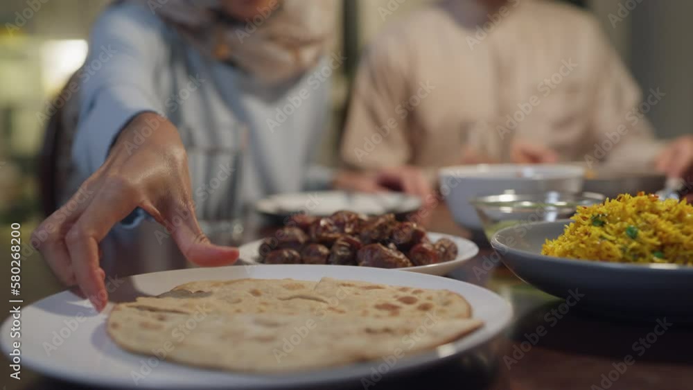 Closeup bread dish Islam woman grab naan bread for break feast. Eid
