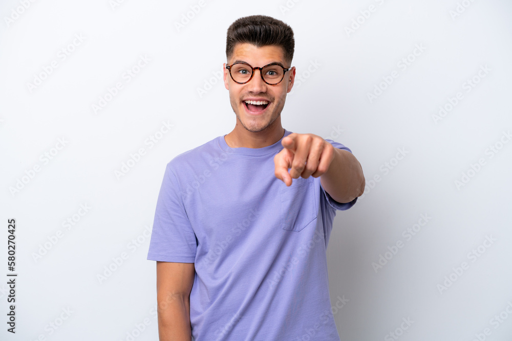 Young caucasian man isolated on white background surprised and pointing front Young caucasian man isolated on white background surprised and pointing front