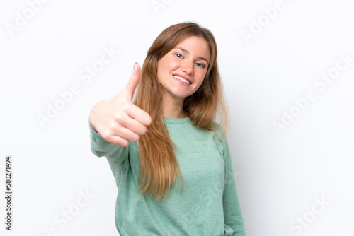 Young caucasian woman isolated on white background with thumbs up because something good has happened