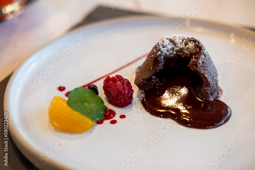 Chocolate lava on plate  with fruit and sauce