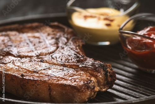pork steak with vegetables in a black iron pan