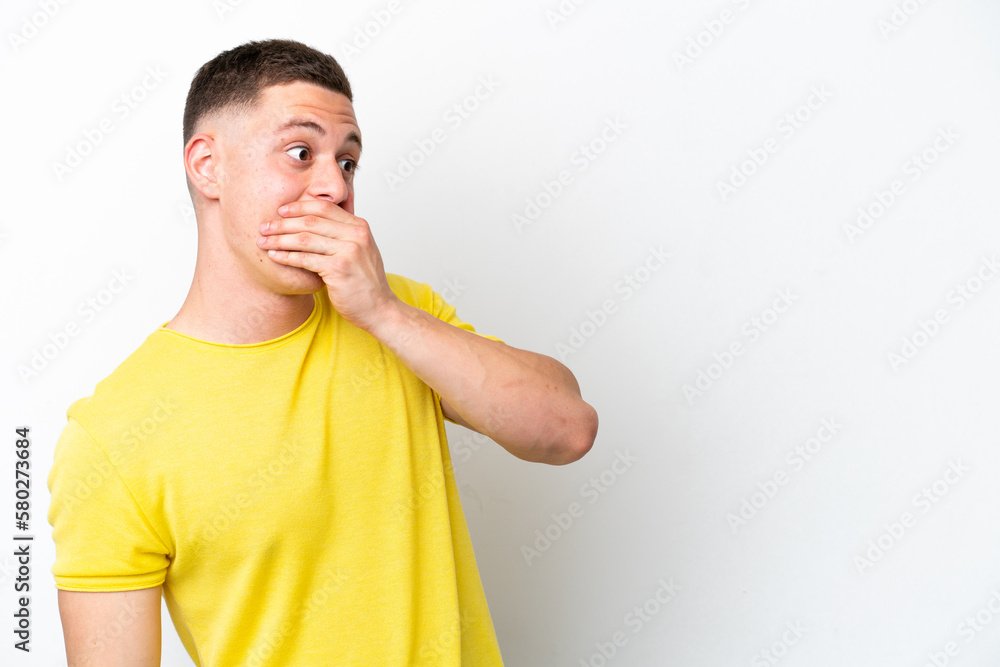 Young brazilian man isolated on white background doing surprise gesture while looking to the side Young brazilian man isolated on white background doing surprise gesture while looking to the side