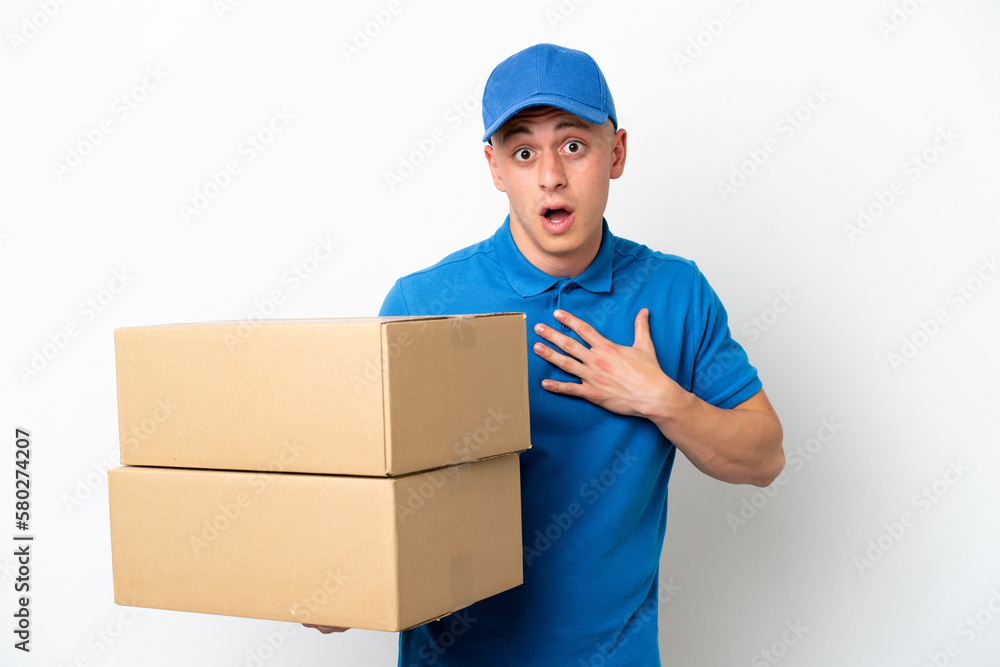 Young delivery Brazilian man isolated ops white background surprised and shocked while looking right Young delivery Brazilian man isolated ops white background surprised and shocked while looking right