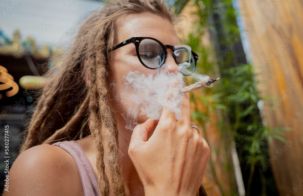 Hippie style woman smoking cigarettes with medical marijuana Stock Photo Adobe Stock