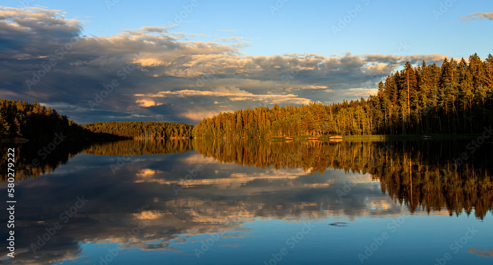Idyllic panorama landscape of Swedish lake sunset