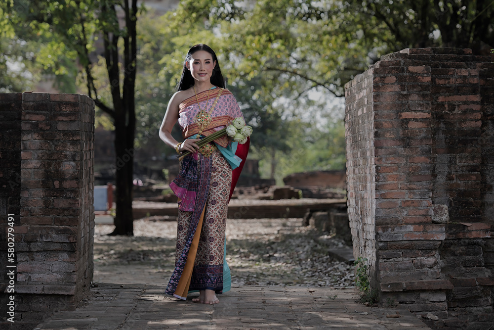 Portrait woman in a dress. Beautiful woman in Thai traditional in Ayutthaya, Thailand. Portrait woman in a dress. Beautiful woman in Thai traditional in Ayutthaya, Thailand.