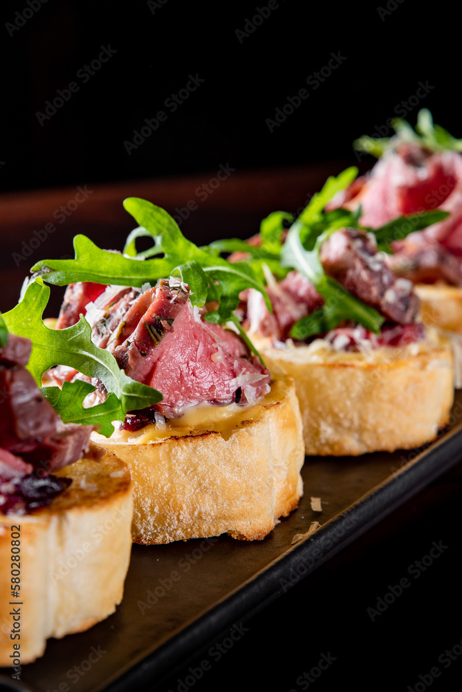 bruschetta with roast beef and cheese on plate bruschetta with roast beef and cheese on plate