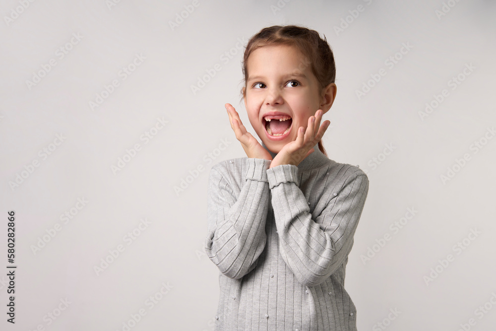Happy child girl with open hands. Surprised girl portrait Happy child girl with open hands. Surprised girl portrait