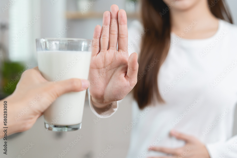 lactose intolerance concept. Woman having a stomach ache from lactose intolerance. lactose intolerance concept. Woman having a stomach ache from lactose intolerance.