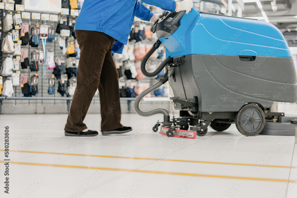 Fototapeta premium cleaning floor with machine