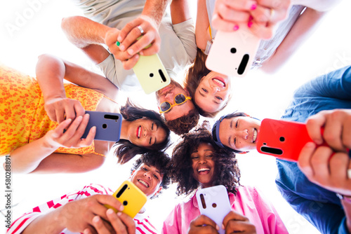 Multiethnic group of happy friends bonding and having fun at the beach on summer vacation - Multiracial real authentic people spending time together at the sea, concepts about youth and summertime