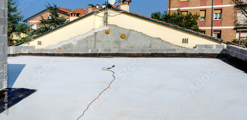 Flat terrace of a house ready for bituminous membrane paving. Propane gas torch is ready on the terrace for the application of bituminous membrane