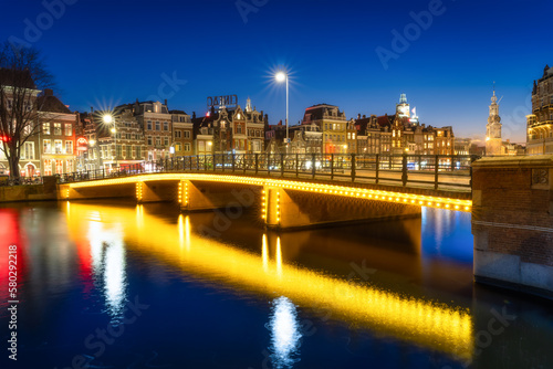 Amsterdam, Netherlands. Evening cityscape. Dark sky and city lights. Dutch ca...