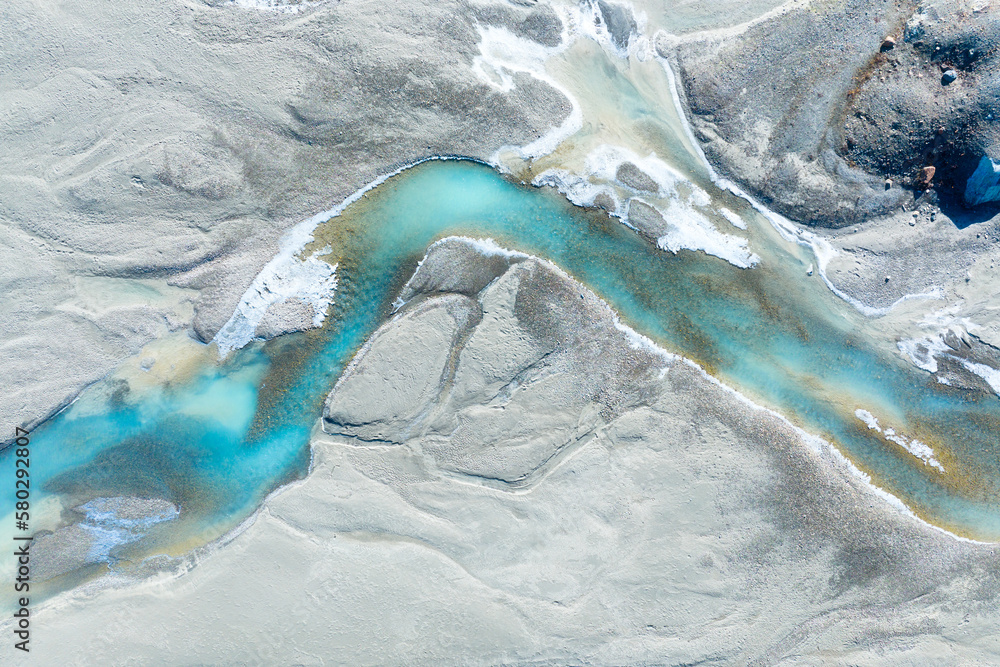 Drone view of the azure river in the glacier valley. View of the moraines. Landscape from the air. River on a moraine. Landscape from drone. Alberta, Canada.