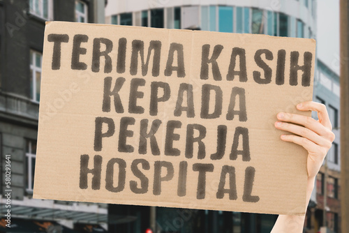 The phrase " Thank you hospital workers " on a banner in hand. The Human holds cardboard with an inscription. Gratitude to healthcare staff. Heroes. People who save lives. Thankfulness. Life