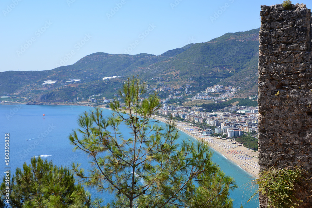 A view to the beach in Alanya town from the hill with brick wall of ancient castle