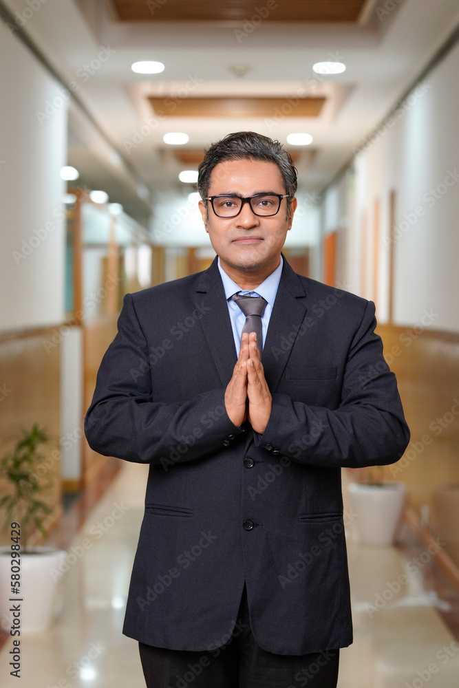 Indian businessman giving namaste or welcome gesture Indian businessman giving namaste or welcome gesture