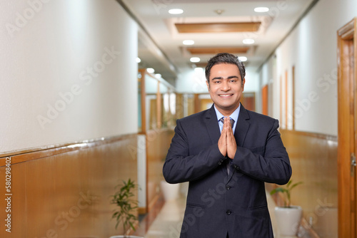 Fotografie Indian businessman giving namaste or welcome gesture