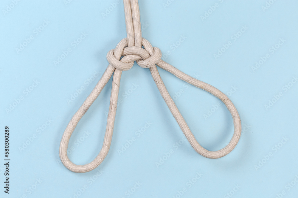 Rope knot Spanish bowline on a blue background