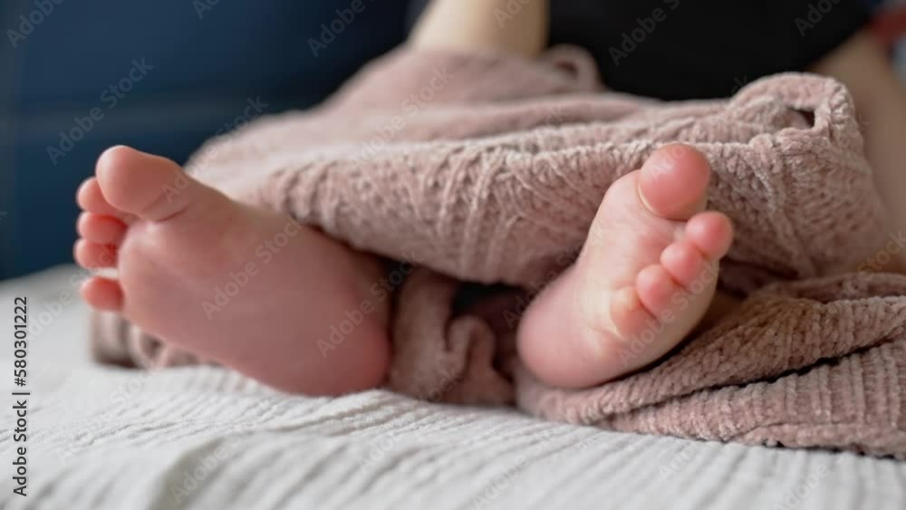close-up of cute baby feet. perfect baby a legs close-up. family newborn baby birth kid dream concept. newborn feet in focus. baby legs: close-up on a beautiful lifestyle background close-up of cute baby feet. perfect baby a legs close-up. family newborn baby birth kid dream concept. newborn feet in focus. baby legs: close-up on a beautiful lifestyle background