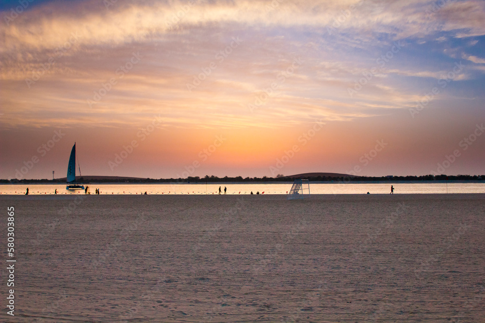 Fototapeta premium sunset on the beach with orange and blue sky