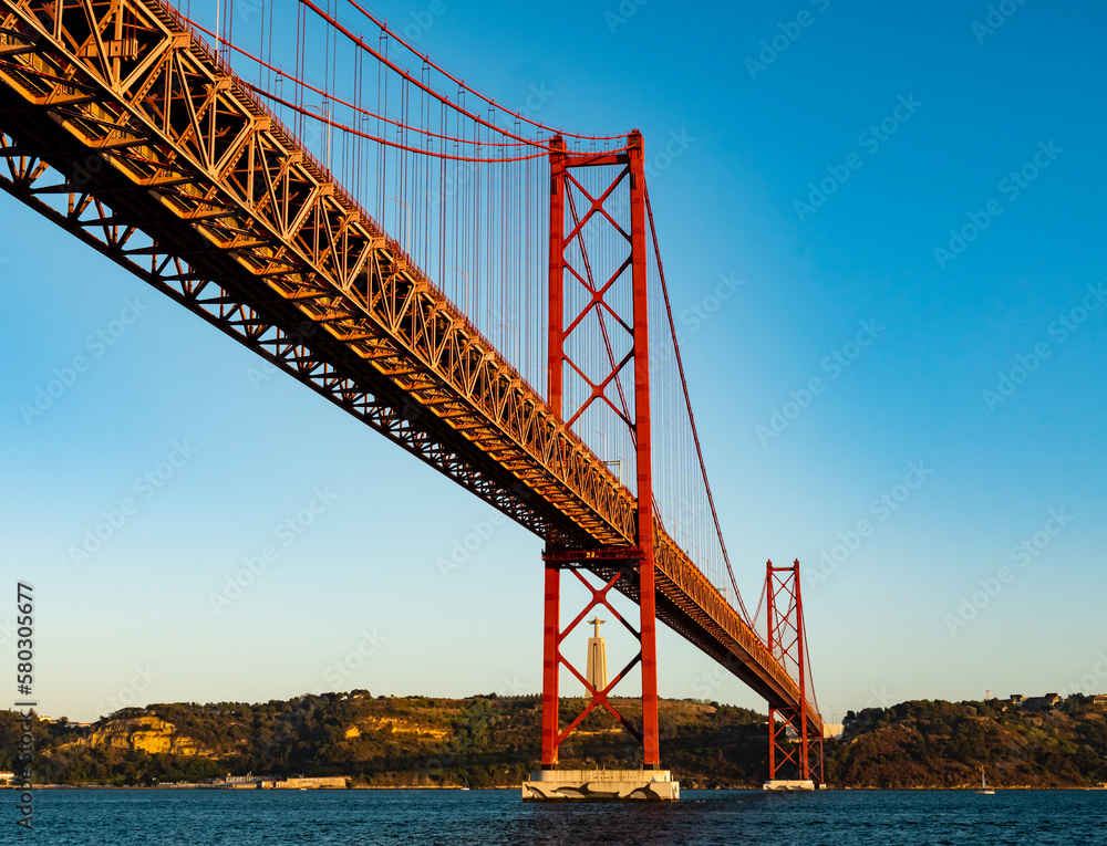 Fototapeta premium Impressive view of the 25 de Abril (25th April) suspension bridge crossing the Tagus river, Belem district, Lisbon, Portugal