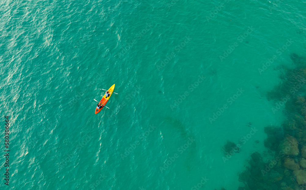 	
Aerial view of a kayak in the blue sea .Woman kayaking She does water sports activities.Natural and lifestyle tourism