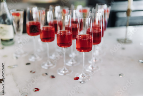 soft focus. Glasses with Rose wine for guests at the buffet table before the wedding ceremony. A lot of glasses with red champagne on the banquet table. Festive table setting. Wine for the holiday