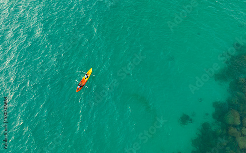  Aerial view of a kayak in the blue sea .Woman kayaking She does water sports activities.Natural and lifestyle tourism