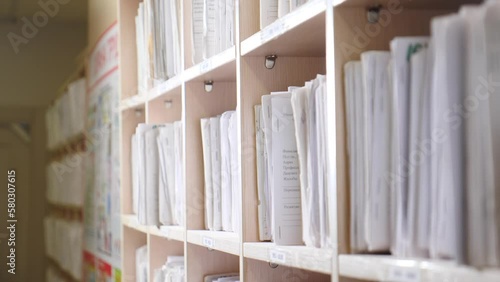 Medical records in archives. catalog in clinic. Healthcare clinic. Oldfashioned medical cards on shelves in hospital. Health insurance folders in archive files. Patient healthcare information. 4 k