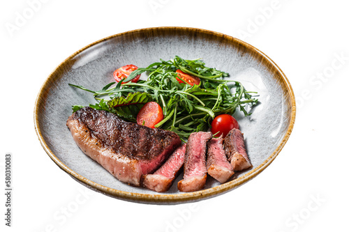 Grilled Top sirloin beef meat steak in plate with vegetable salad.  Isolated, transparent background