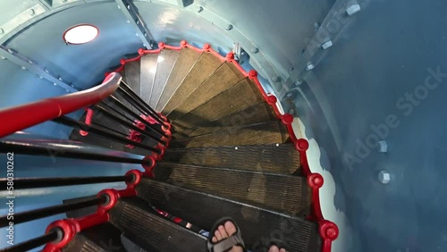 Descending the narrow and steep stairs in the Kihnu lighthouse in Estonia. photo