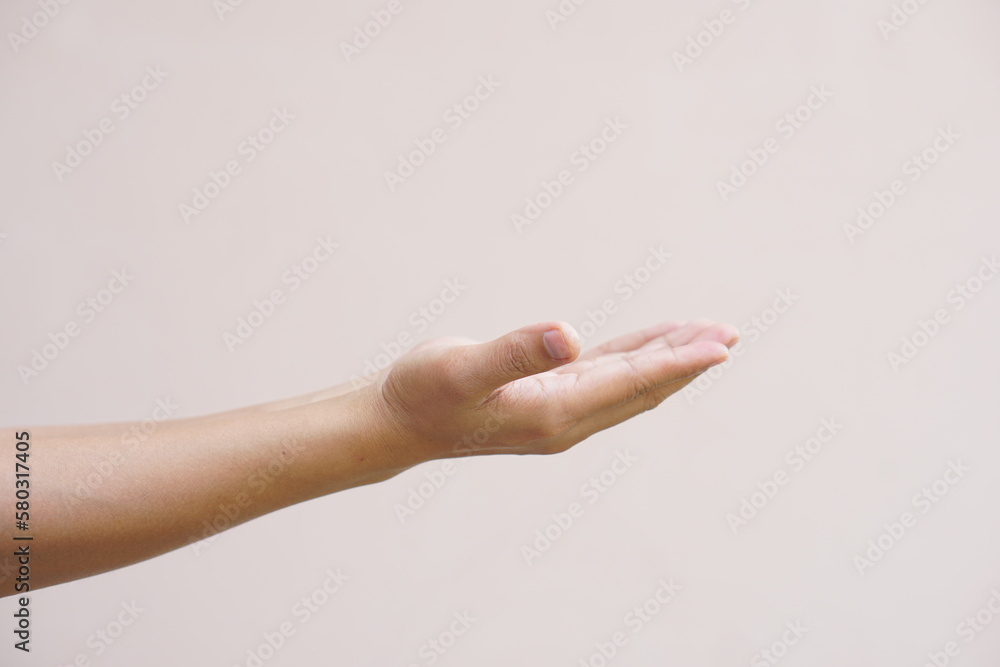 An Asian woman stretches her hand to the side like an empty object on her hand. An Asian woman stretches her hand to the side like an empty object on her hand.